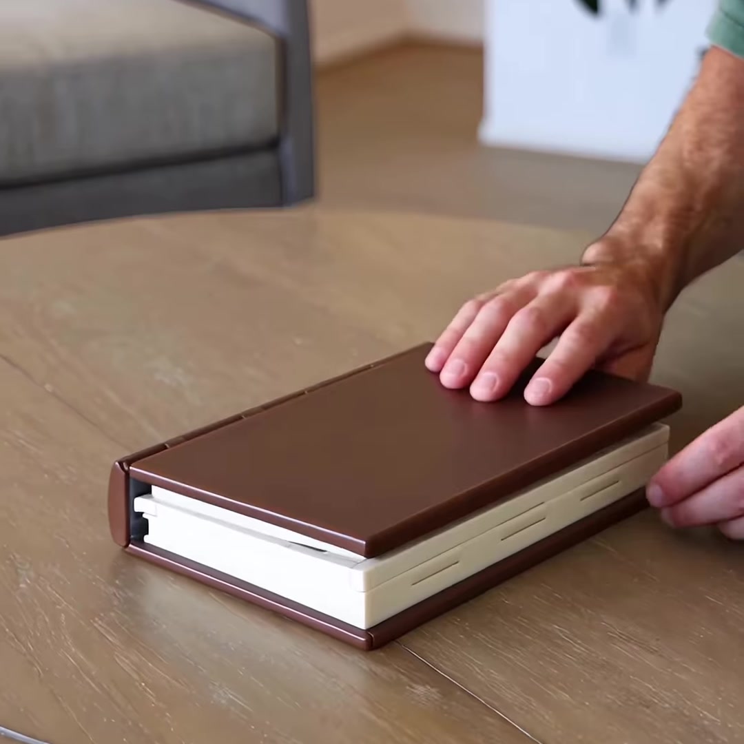 Folding chess book set closed, brown hardcover look on a table