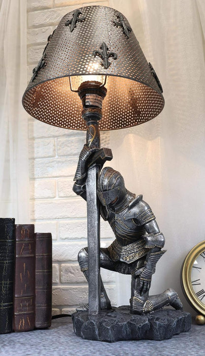 Kneeling knight lamp on a shelf next to leather books and a clock