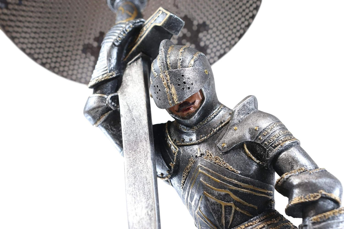 Close up of the knight in full plate armor with head bowed over the sword