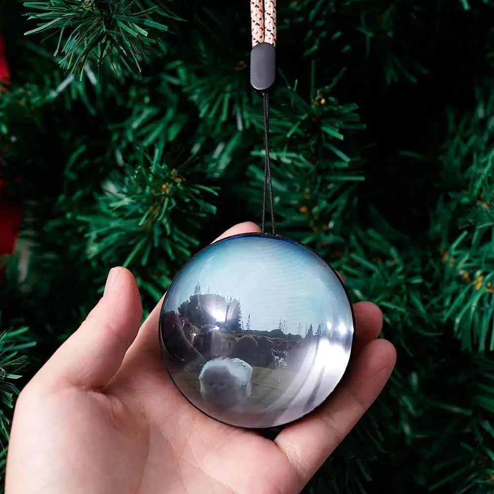 Hand holding the crystal ball video orb to show its size