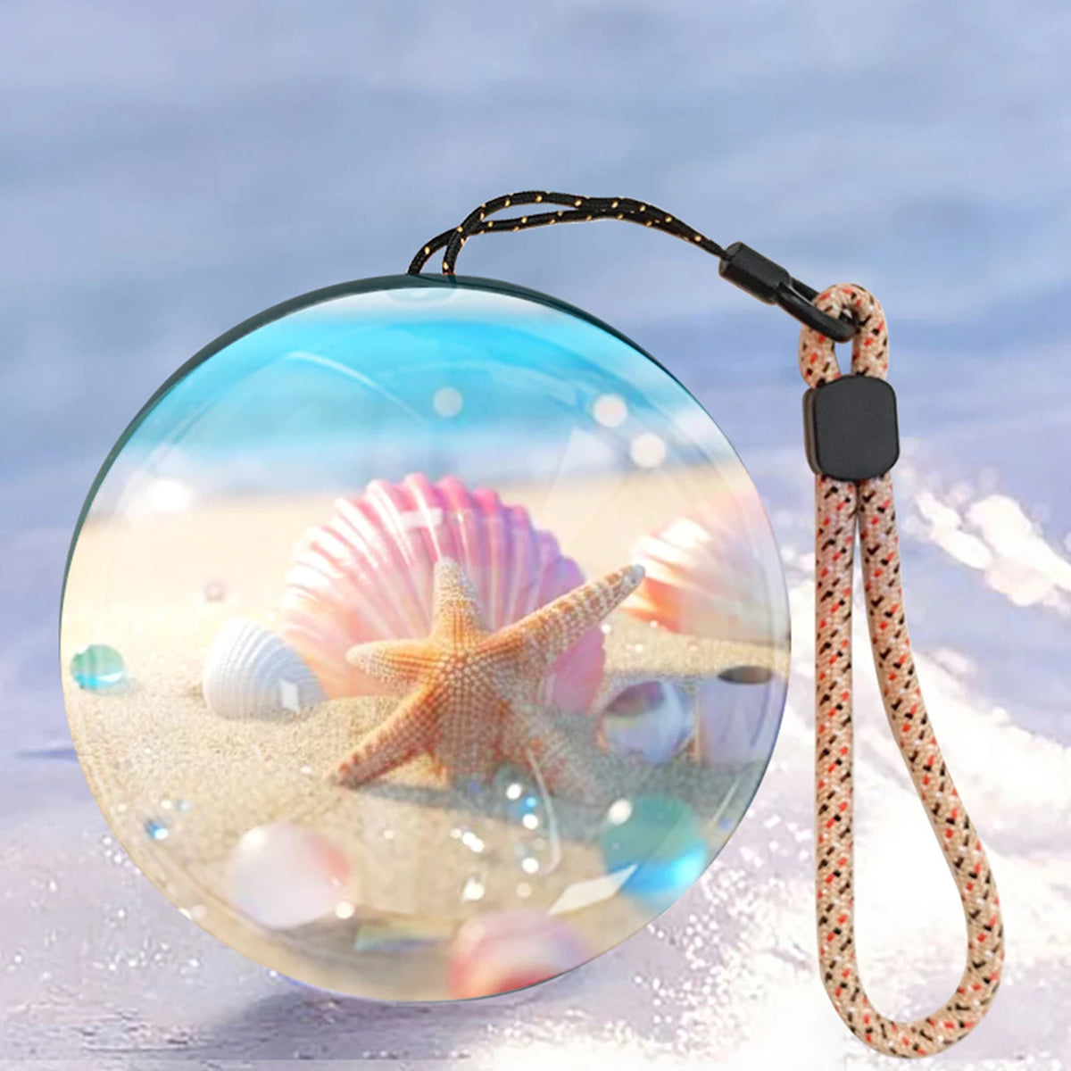 Video orb glowing with a beach and seashell scene inside the glass sphere