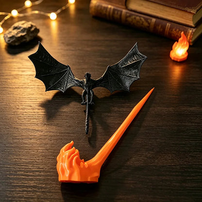 Two piece dragon sculpture: black winged dragon and orange flame base before assembly