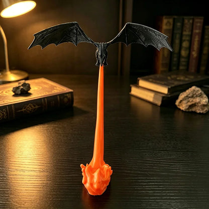 Front view of the black dragon with wings spread above its orange fire breath
