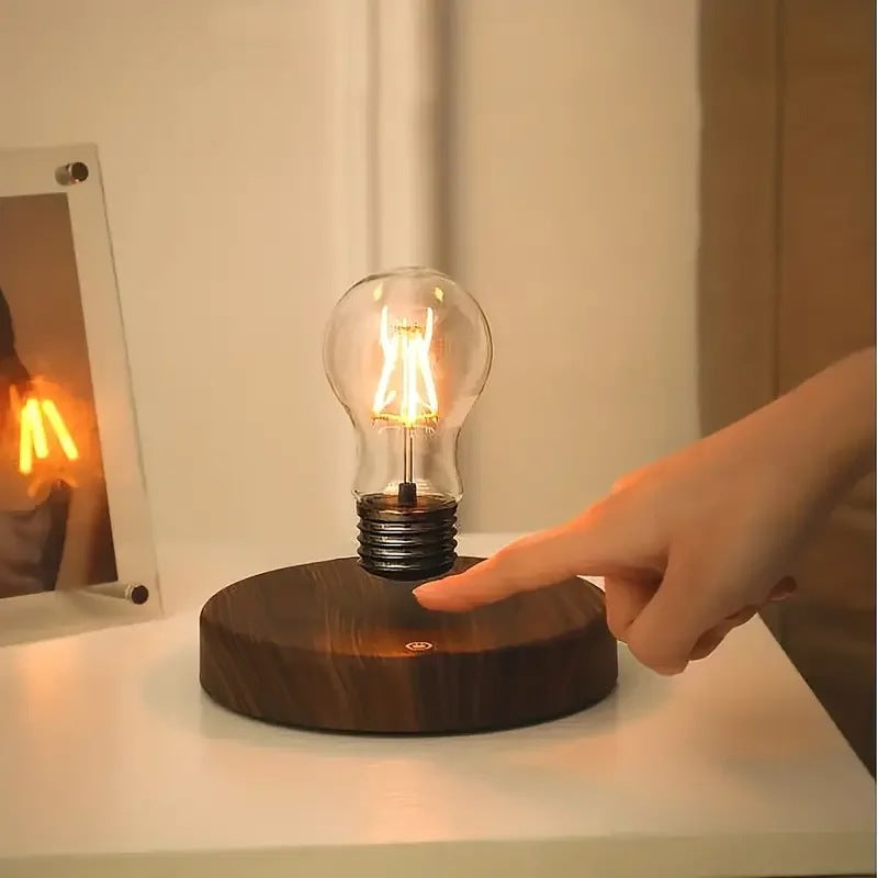 Finger tapping the touch switch on the base of the levitating bulb lamp