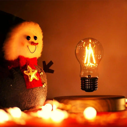 Floating bulb lamp glowing warmly beside holiday decor as a gift idea