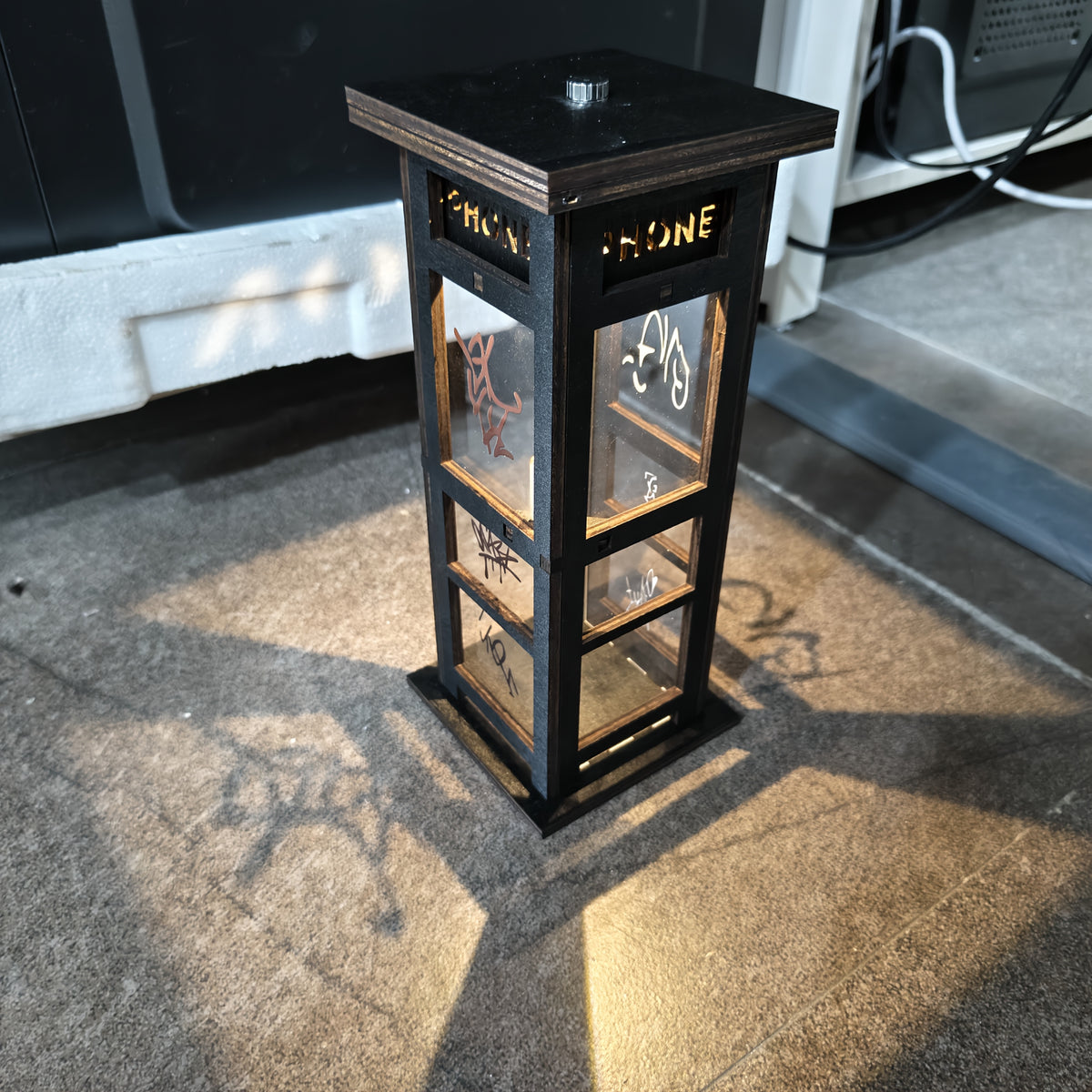 Top of the Graffiti phone booth lamp with the battery holder